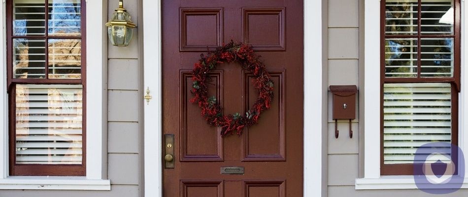Front door to a home with a wreath decoration
