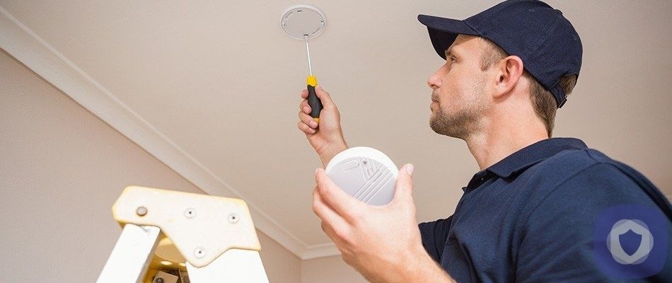 Man installing a smoke detector